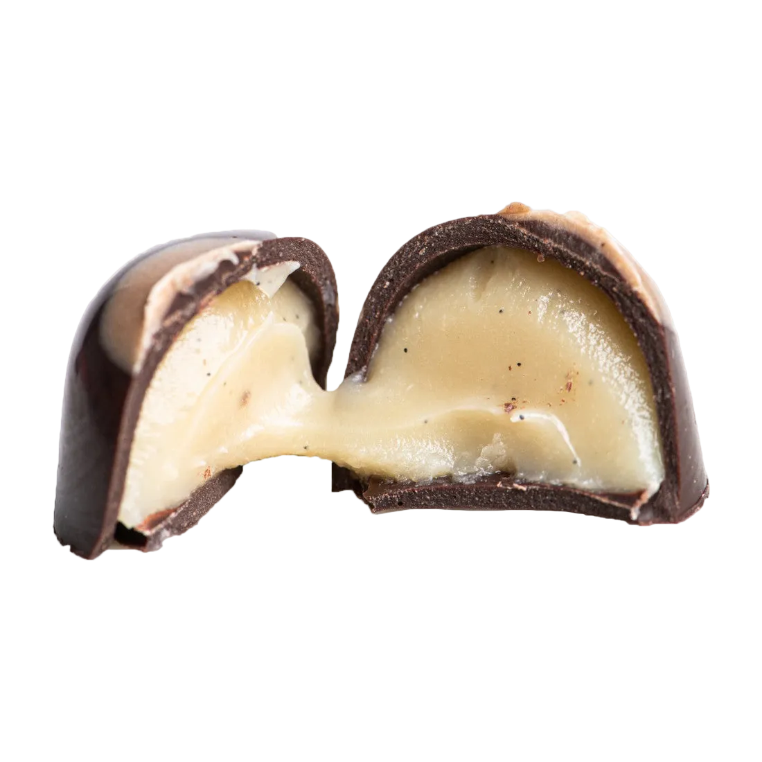 A piece of dark chocolate candy cut in half, revealing a creamy, gooey caramel filling oozing out, against a white background.