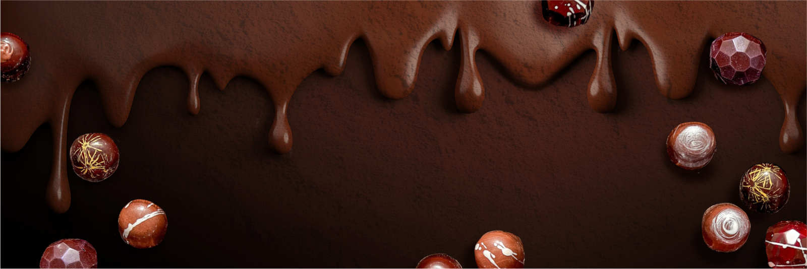 Assorted round chocolates are scattered on a dark surface, with melted chocolate dripping from the top, creating a rich and indulgent scene.