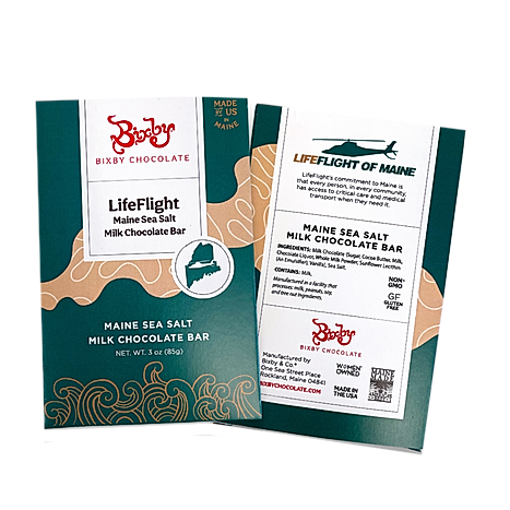 Two Bixby Chocolates LifeFlight Maine Sea Salt Milk Chocolate Bars shown; packaging in green, gold, and white features the Maine state outline, ingredient info, and highlights support for Life Flight of Maine emergency air transport.