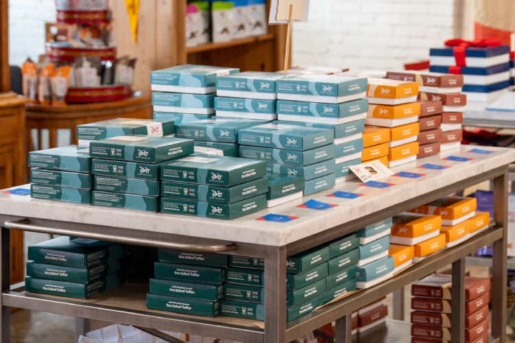 An image of Bixby warehouse with boxes of chocolates on shelves and workers grabbing them.