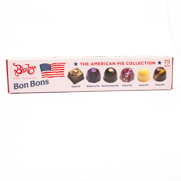 A long rectangular box of Bon Bons baby chocolates from Berlin, featuring 'The American Pie Collection' with illustrations of various pie-flavored chocolates and an American flag graphic on a white background.