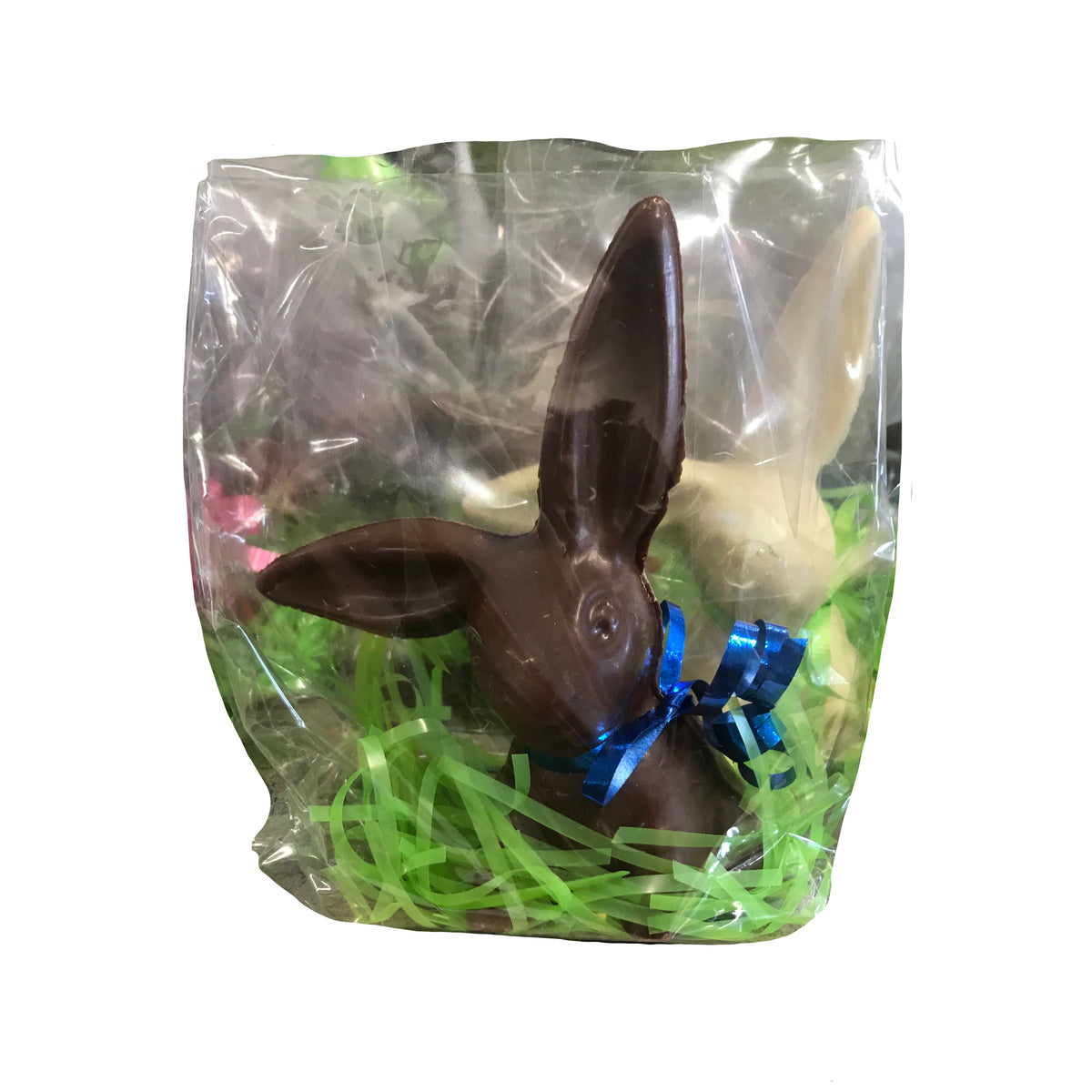 A Bixby Chocolates “Chocolate Bunnies--For Pick Up” treat, wrapped in clear plastic with a blue ribbon and set on green Easter grass, makes a perfect gift—plus there’s a white chocolate bunny peeking from the background.
