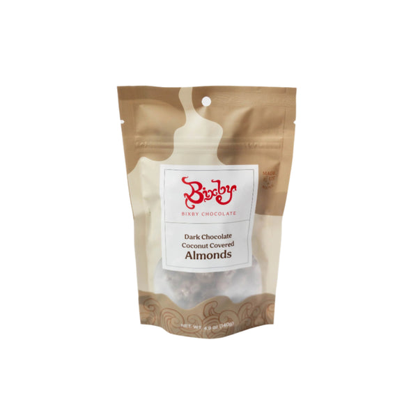A beige and white stand-up pouch of Bixby Chocolates Dark Chocolate Coconut Almonds, made with small batch chocolate, displays the Bixby logo and product name on the front. The sealed pouch is shown against a white background.