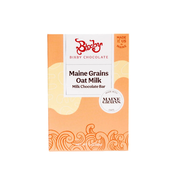 A box of Bixby Chocolates Organic Maine Grains Oat Milk Chocolate Bar (Vegan), with an orange and cream wave design, showcases this plant-based chocolate made in the USA with Maine Grains oats.