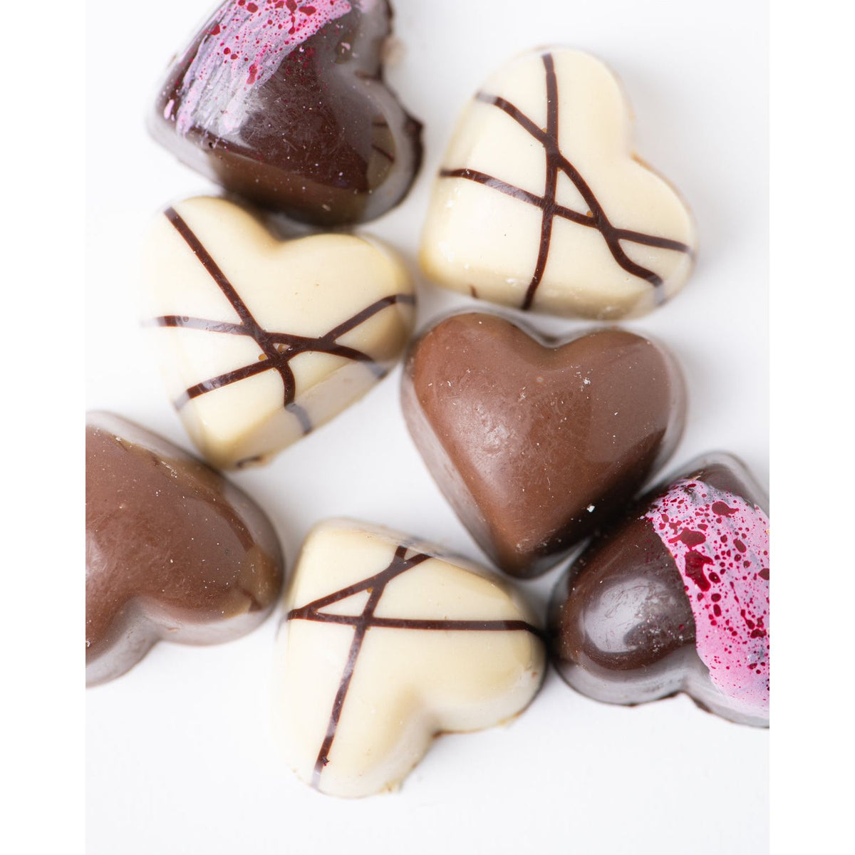 Bixby Chocolates’ 3 Months of Chocolate Heart Love features seven heart-shaped bon bons in dark and white chocolate, decorated with lines or pink splashes, in flavors such as blood orange caramel and passion fruit ganache.